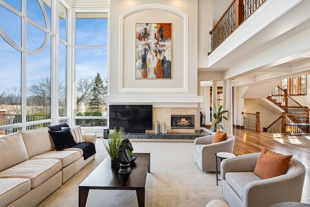 sunroom / solarium featuring a fireplace and decorative columns