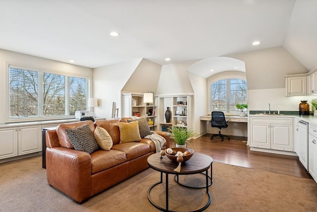 living area with lofted ceiling, wood finished floors, built in study area, and recessed lighting