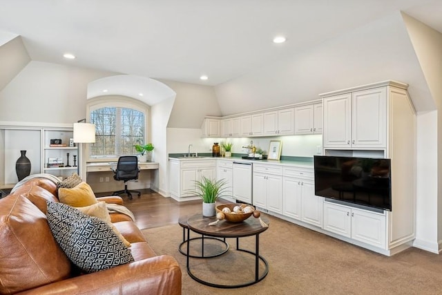 living room featuring vaulted ceiling, baseboards, built in study area, and recessed lighting