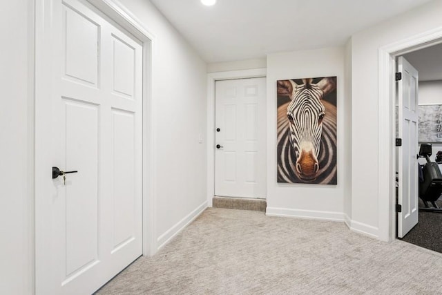 hall featuring carpet floors and baseboards