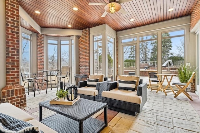 sunroom / solarium with wooden ceiling and a ceiling fan