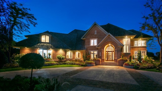 view of front facade with driveway and brick siding