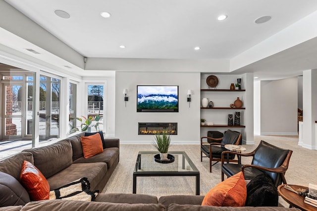18313 Nicklaus Way, Eden Prairie, MN 55347 - living room with light colored carpet, baseboards, a glass covered fireplace, recessed lighting, and built in shelves