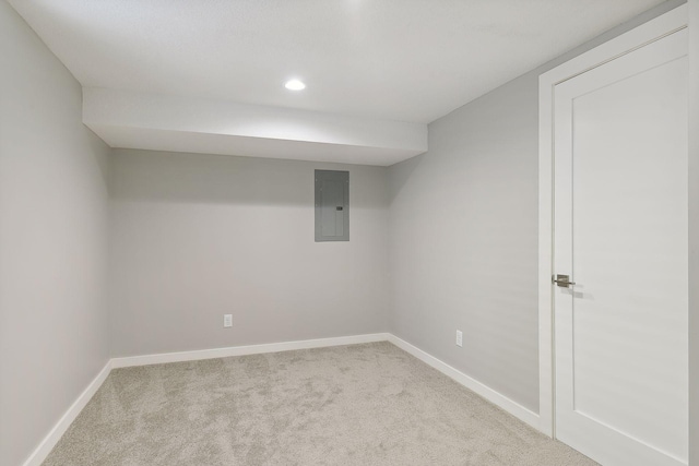 finished basement featuring electric panel, baseboards, and light colored carpet