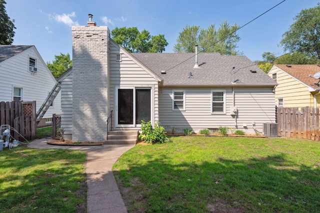 back of property featuring a yard and fence