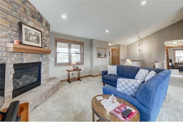 carpeted living room with lofted ceiling, crown molding, and a fireplace