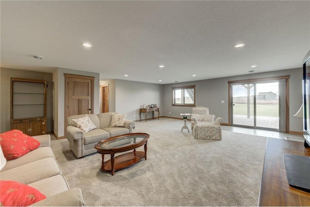 living room featuring light colored carpet and a textured ceiling