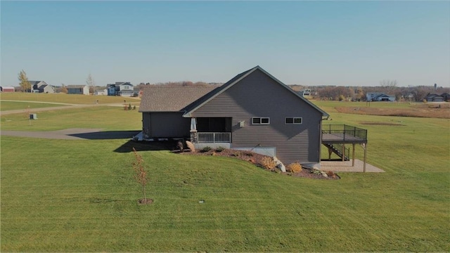 exterior space featuring a wooden deck and a yard