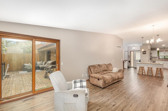 14371 Embry Path, Apple Valley, MN 55124 - living area featuring light wood finished floors and a chandelier