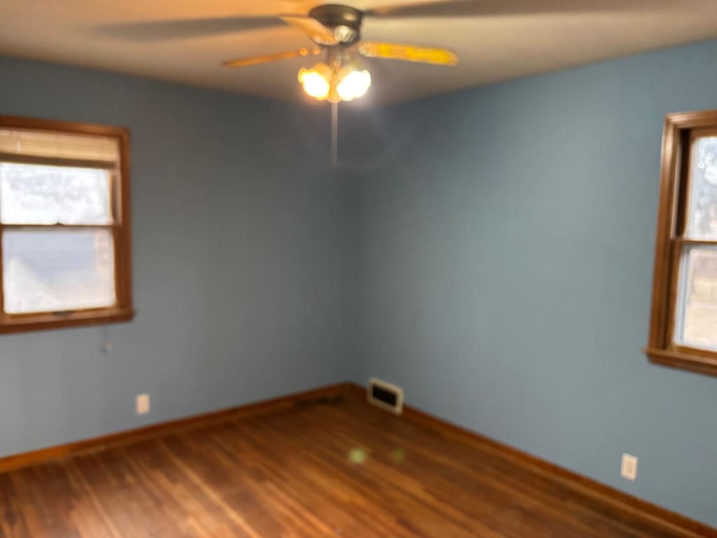 unfurnished room featuring hardwood / wood-style flooring and ceiling fan