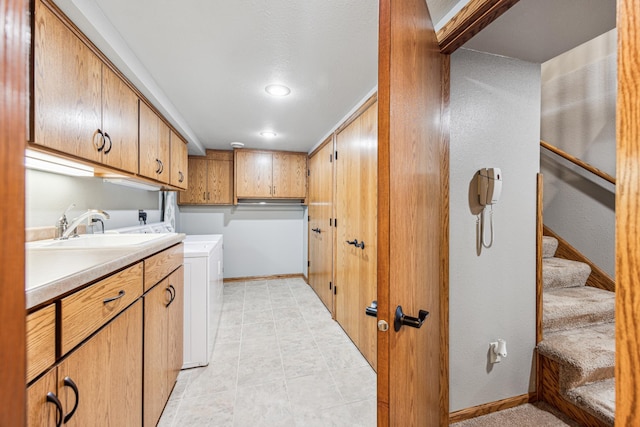 laundry room featuring sink and cabinets