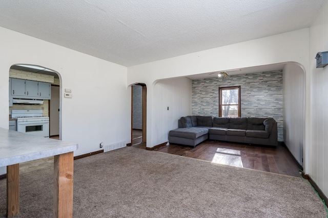 unfurnished living room featuring dark hardwood / wood-style floors and a textured ceiling