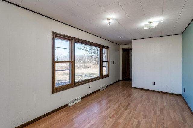 empty room with light hardwood / wood-style flooring