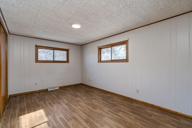 unfurnished room with dark wood-type flooring