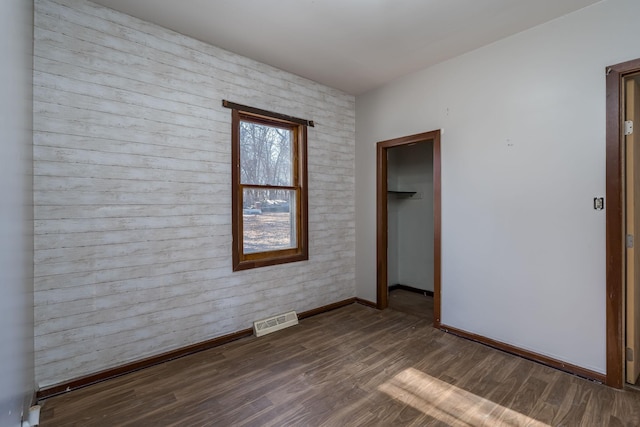 spare room with dark hardwood / wood-style flooring