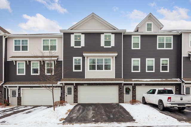 townhome / multi-family property featuring a garage and driveway