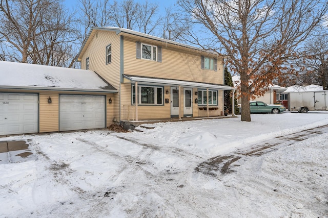 view of front property with a porch and a garage