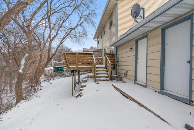 yard covered in snow featuring a deck and stairs