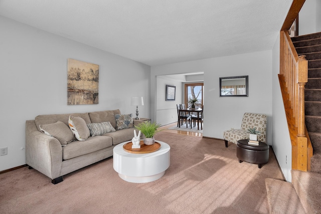 living area with stairs, carpet floors, and baseboards