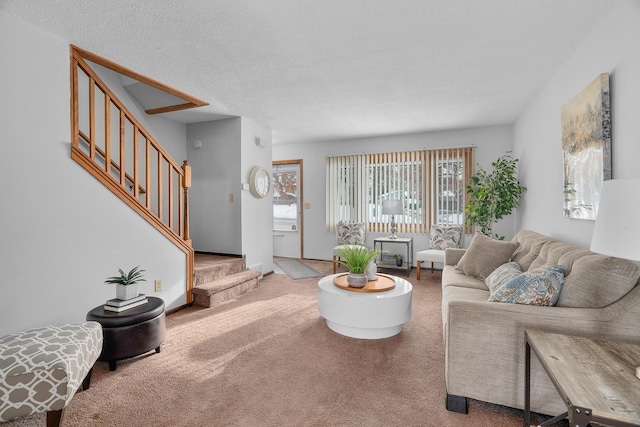 living area with carpet, stairway, and a textured ceiling