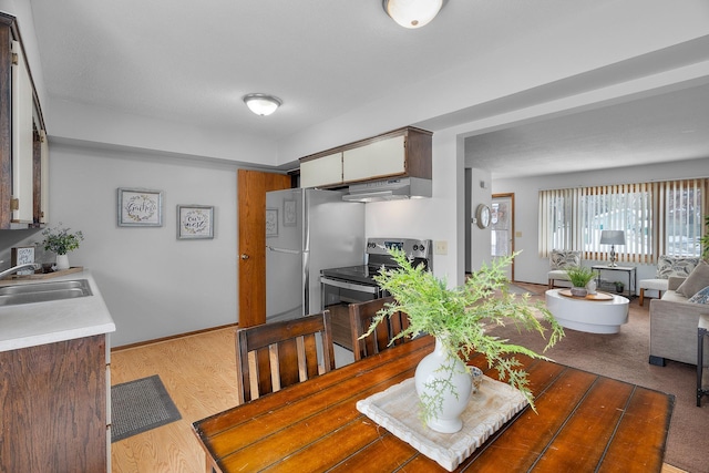 dining room featuring baseboards and wood finished floors