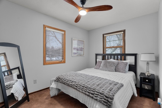 carpeted bedroom with ceiling fan and baseboards