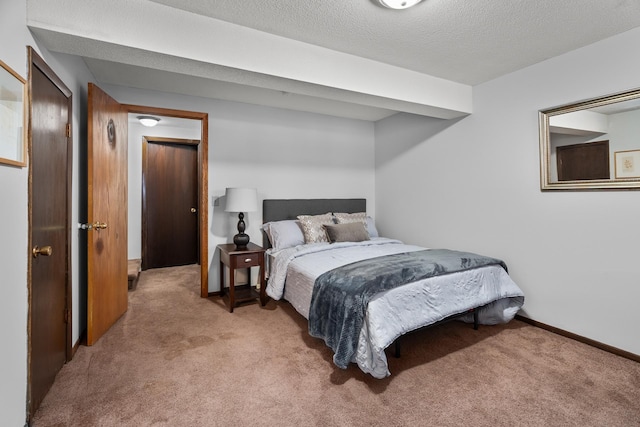 carpeted bedroom with baseboards and a textured ceiling