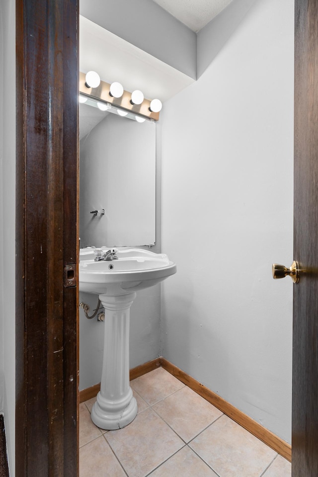 bathroom featuring baseboards and tile patterned floors