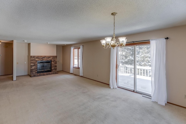 unfurnished living room with a notable chandelier, carpet floors, a textured ceiling, and a fireplace