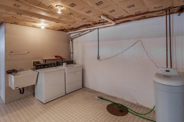 clothes washing area featuring washer and dryer and sink