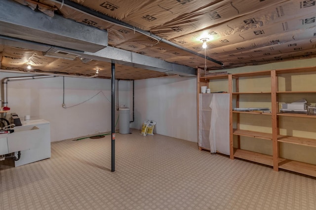 basement featuring sink and washer and clothes dryer