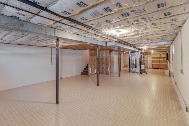 basement featuring water heater and heating unit