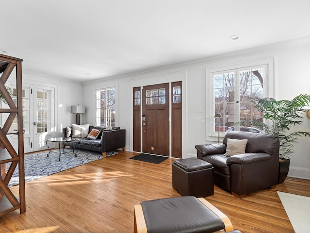 living room featuring hardwood / wood-style flooring and ornamental molding