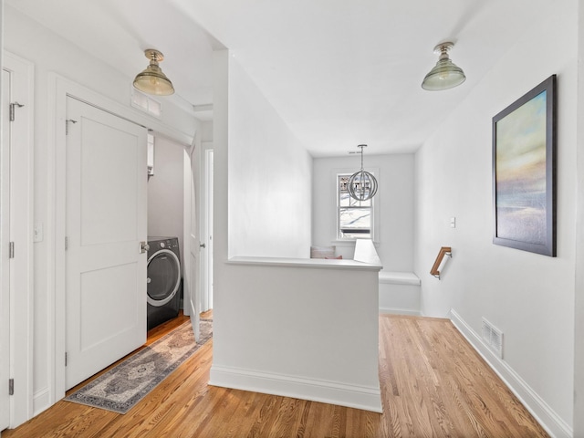 interior space featuring washer / clothes dryer and light hardwood / wood-style floors