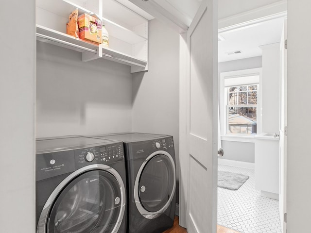 washroom with tile patterned flooring and washer and clothes dryer