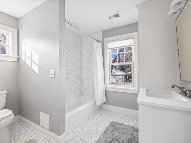 full bathroom featuring a healthy amount of sunlight, toilet, tile patterned flooring, and vanity