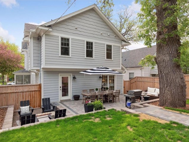 back of house featuring a yard, an outdoor hangout area, and a patio area