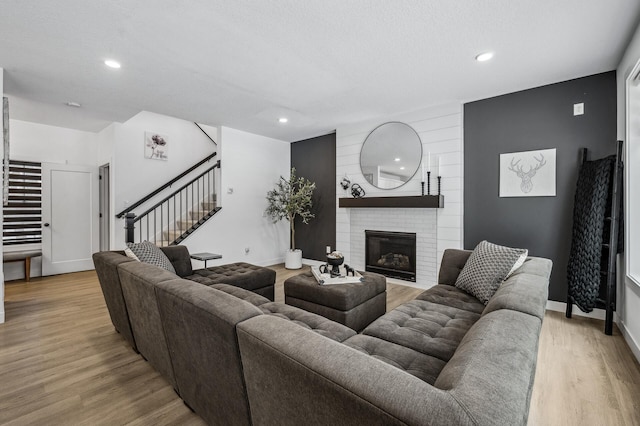 living room with a fireplace and light hardwood / wood-style floors