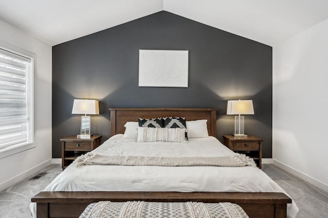 carpeted bedroom featuring lofted ceiling