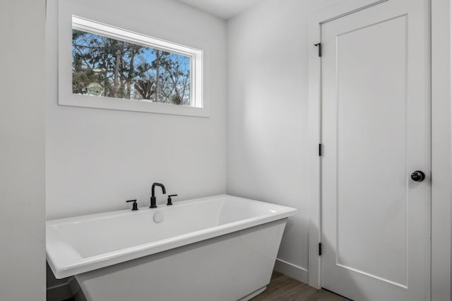 bathroom featuring hardwood / wood-style flooring and a tub