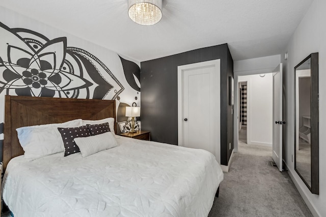 carpeted bedroom featuring a closet and a chandelier