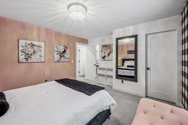 bedroom featuring light carpet and a textured ceiling