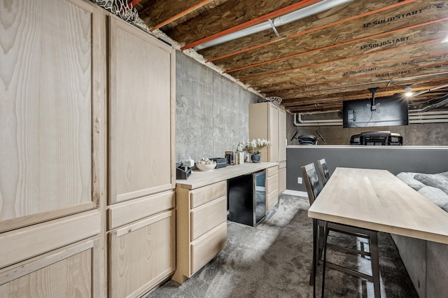 basement featuring dark carpet and refrigerator