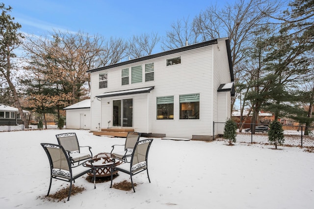 snow covered house featuring a fire pit