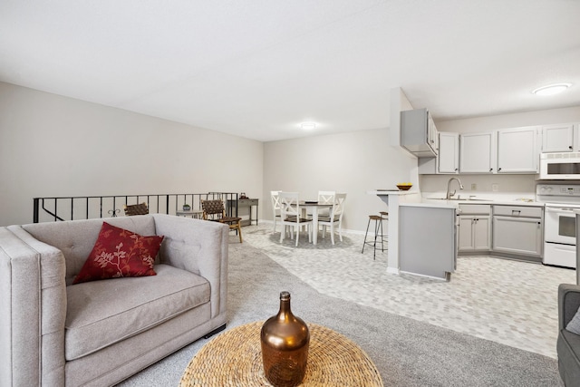 carpeted living room featuring sink