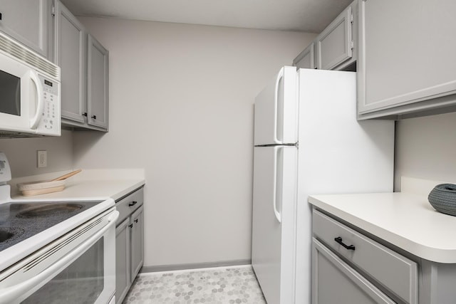 kitchen with white appliances and gray cabinets