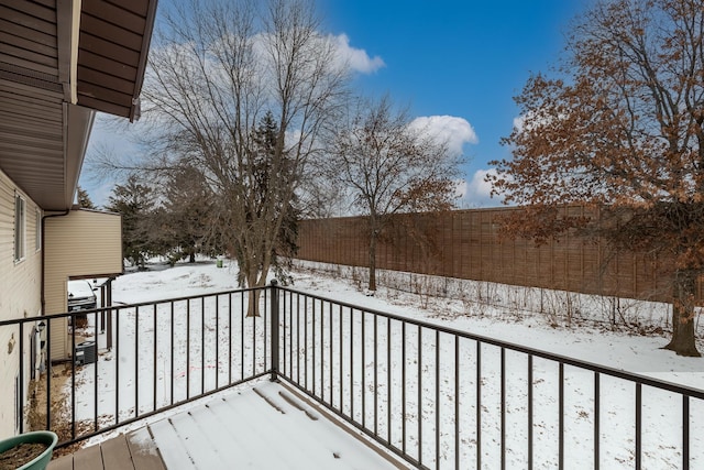 view of snow covered back of property