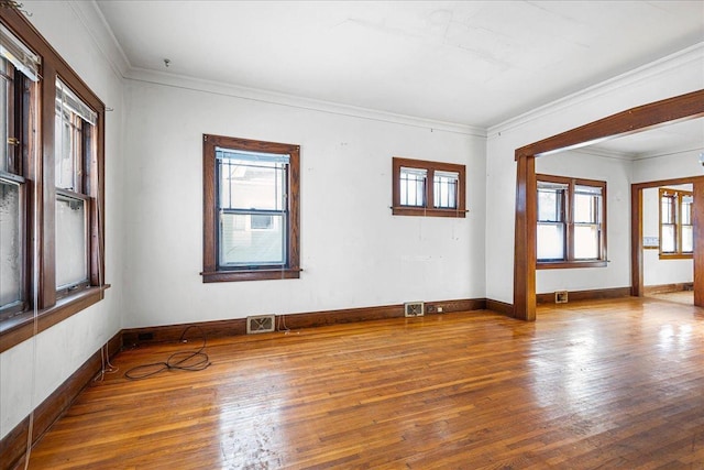 unfurnished room with crown molding and hardwood / wood-style floors