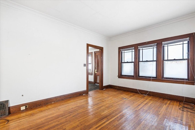 unfurnished room with crown molding and hardwood / wood-style floors