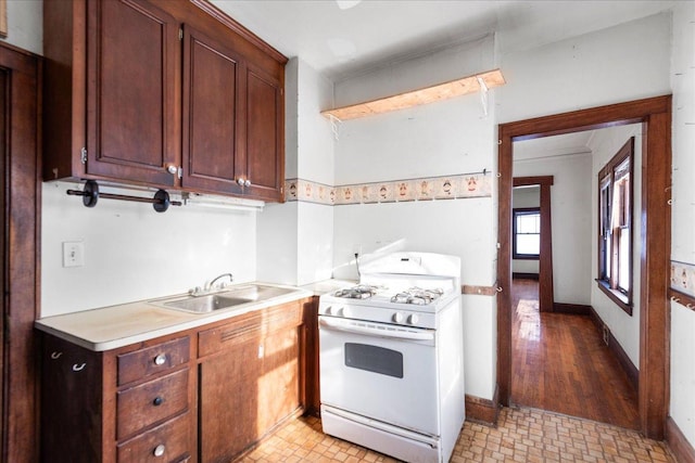 kitchen featuring sink and white gas range oven